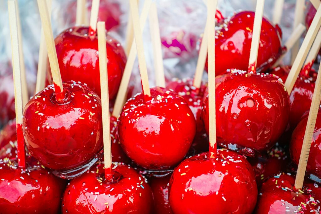 Sweet glazed red toffee candy apples on sticks
